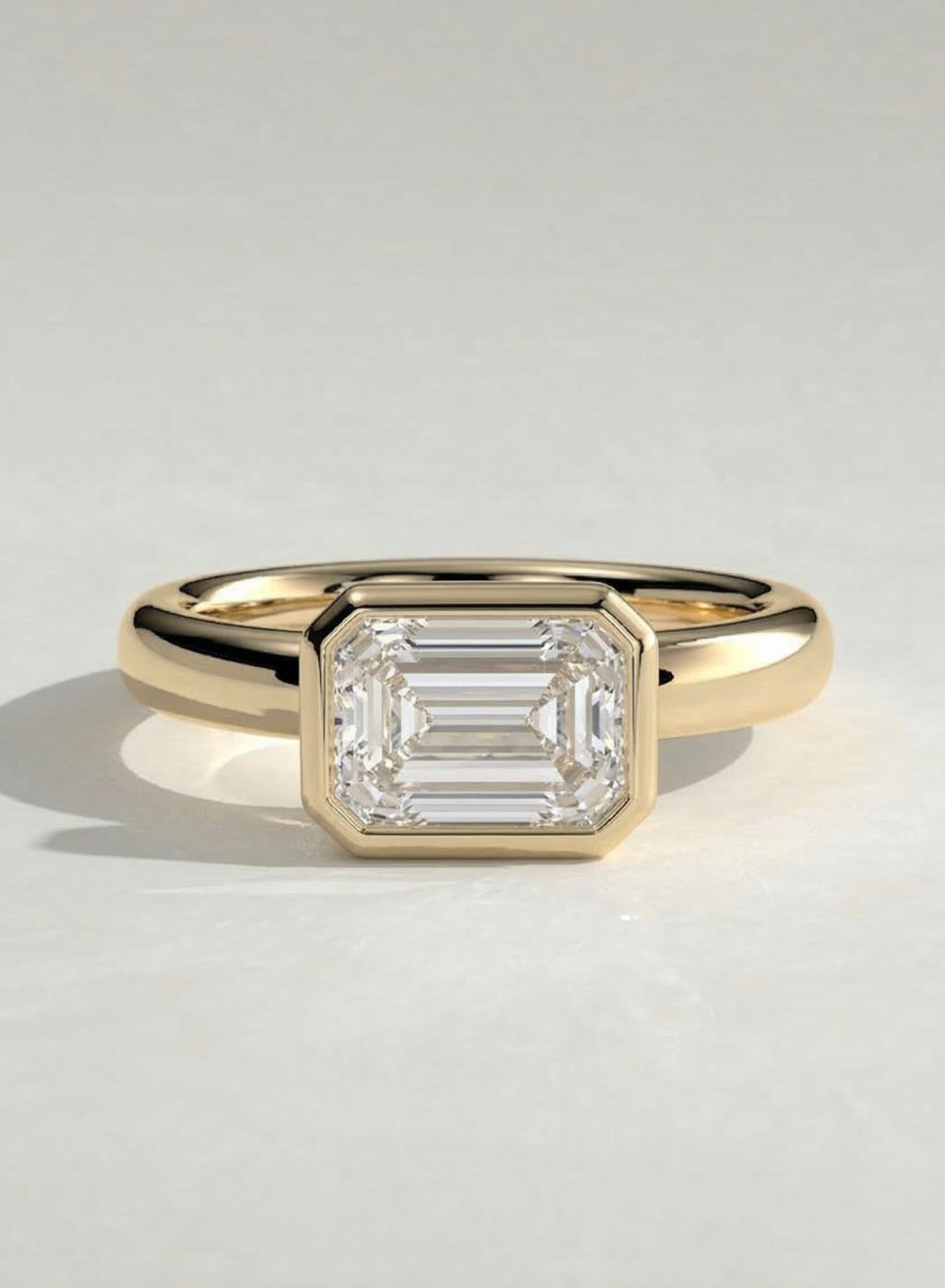 The Alina Ring - East-West Emerald Bezel Solitaire Ring