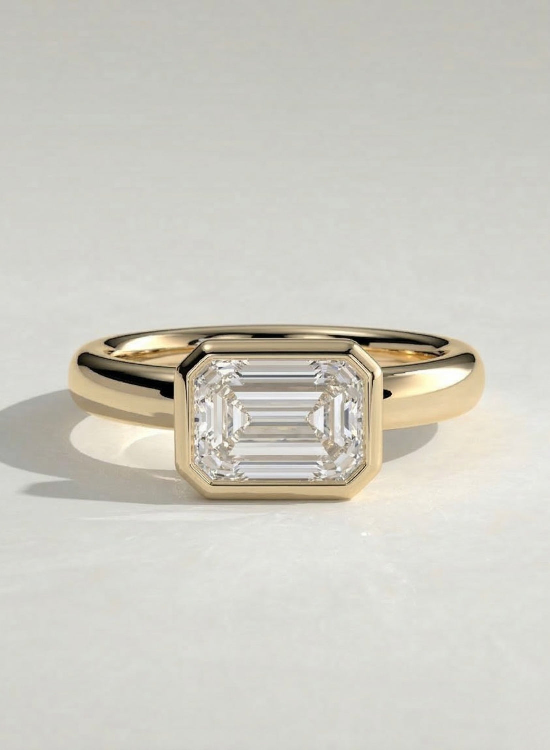 The Alina Ring - East-West Emerald Bezel Solitaire Ring