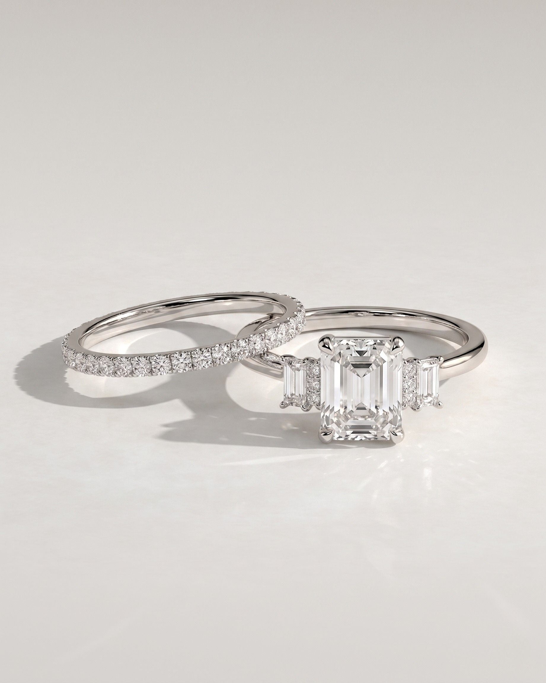 The Geneva Bridal Set - Emerald Cut Three Stone Ring with Pavé Wedding Band