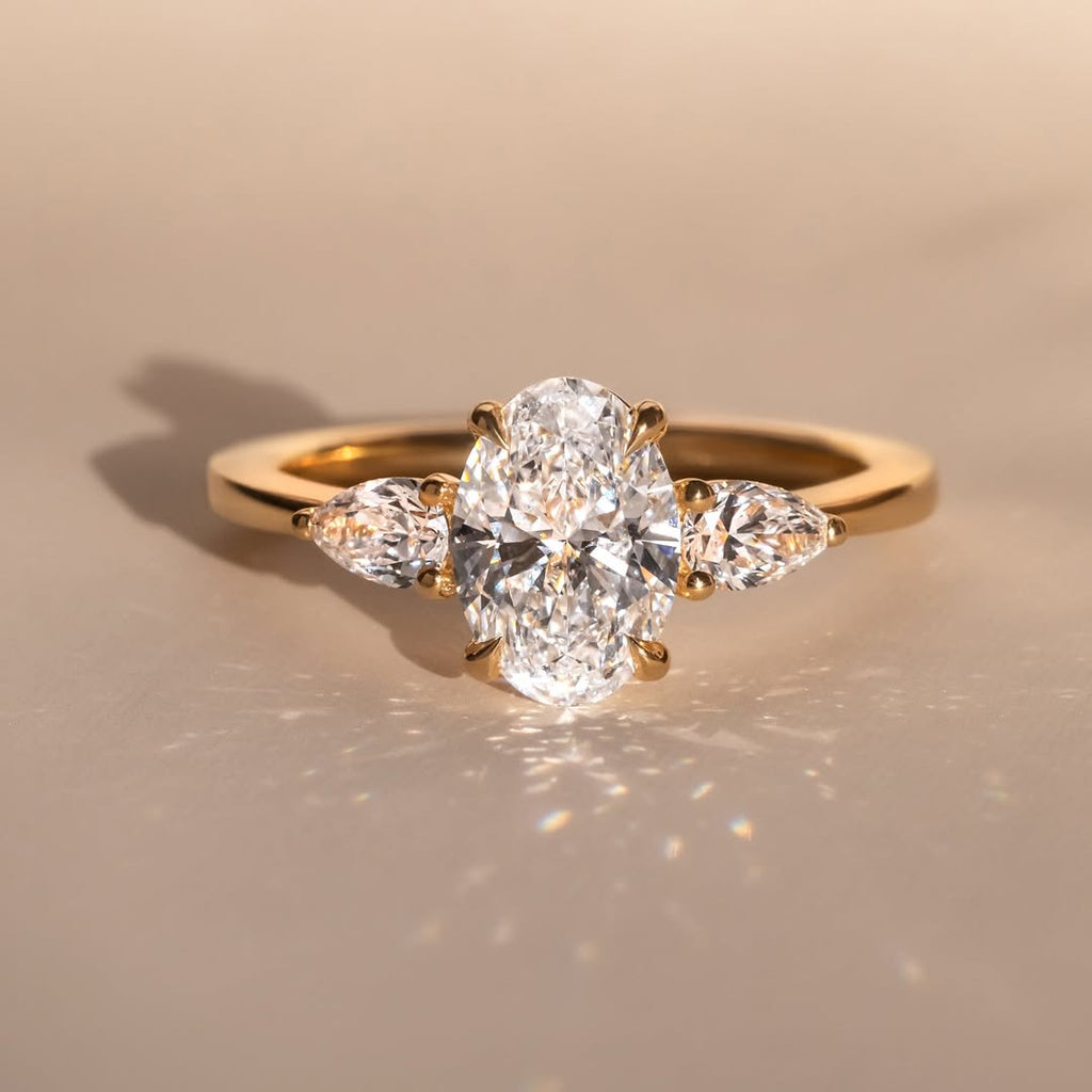 The Nyra Ring – Oval Three Stone Ring with Pear Side Stones
