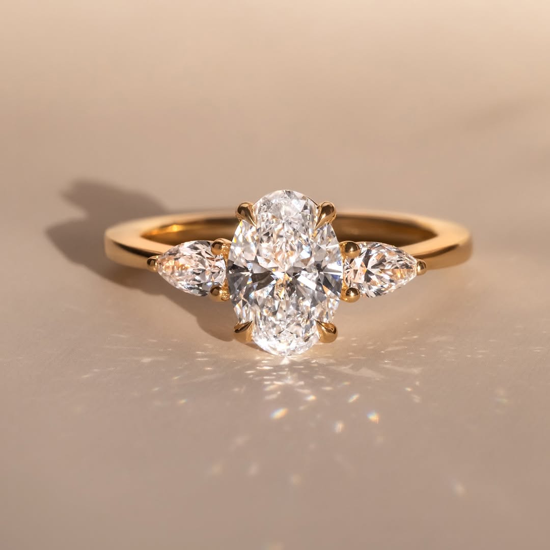 The Nyra Ring – Oval Three Stone Ring with Pear Side Stones
