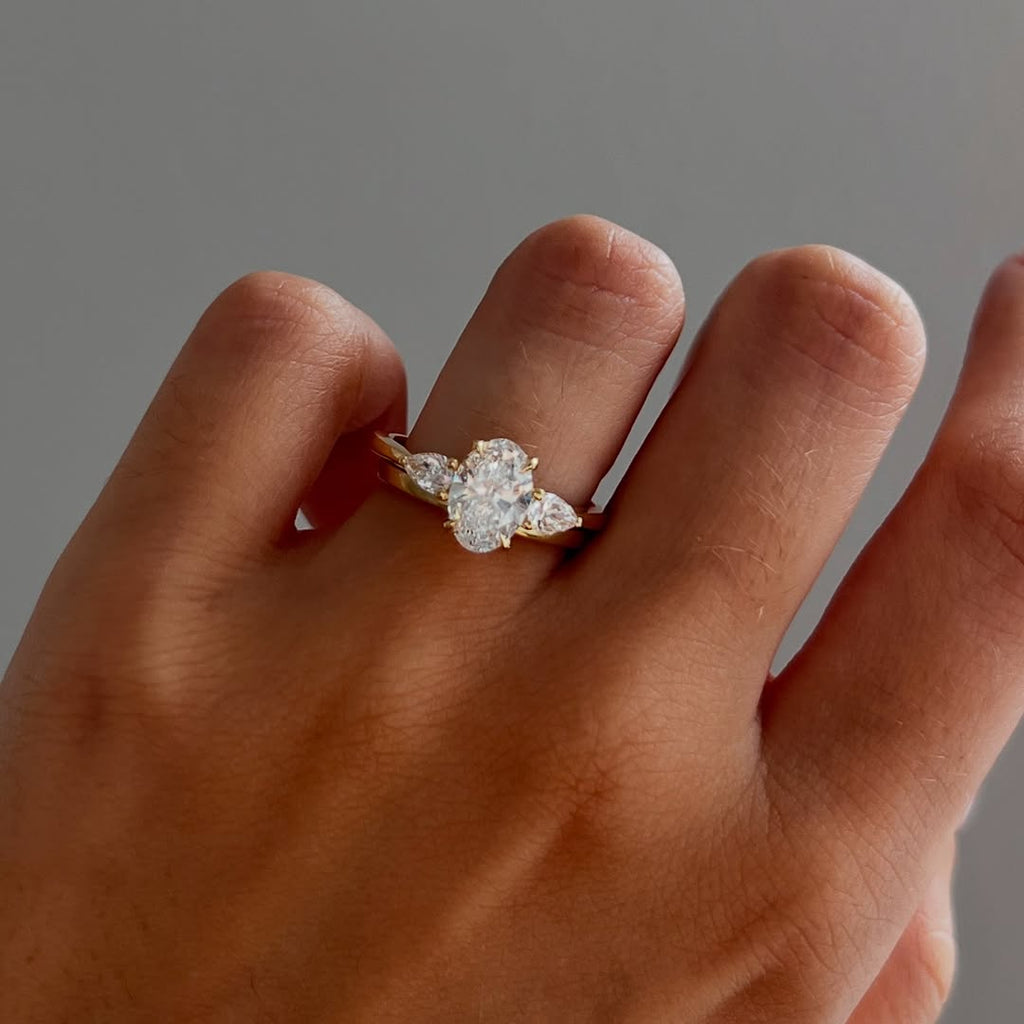 The Nyra Ring – Oval Three Stone Ring with Pear Side Stones