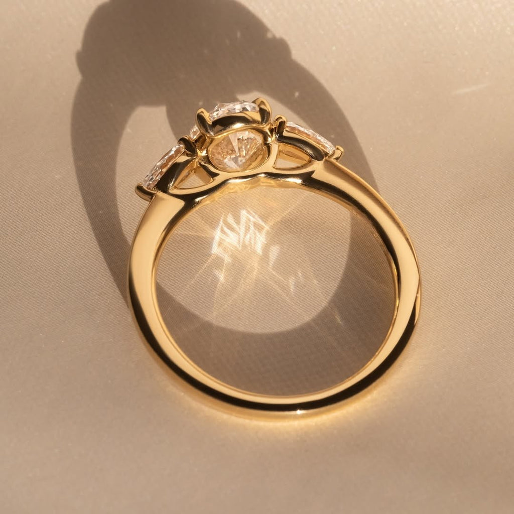 The Nyra Ring – Oval Three Stone Ring with Pear Side Stones