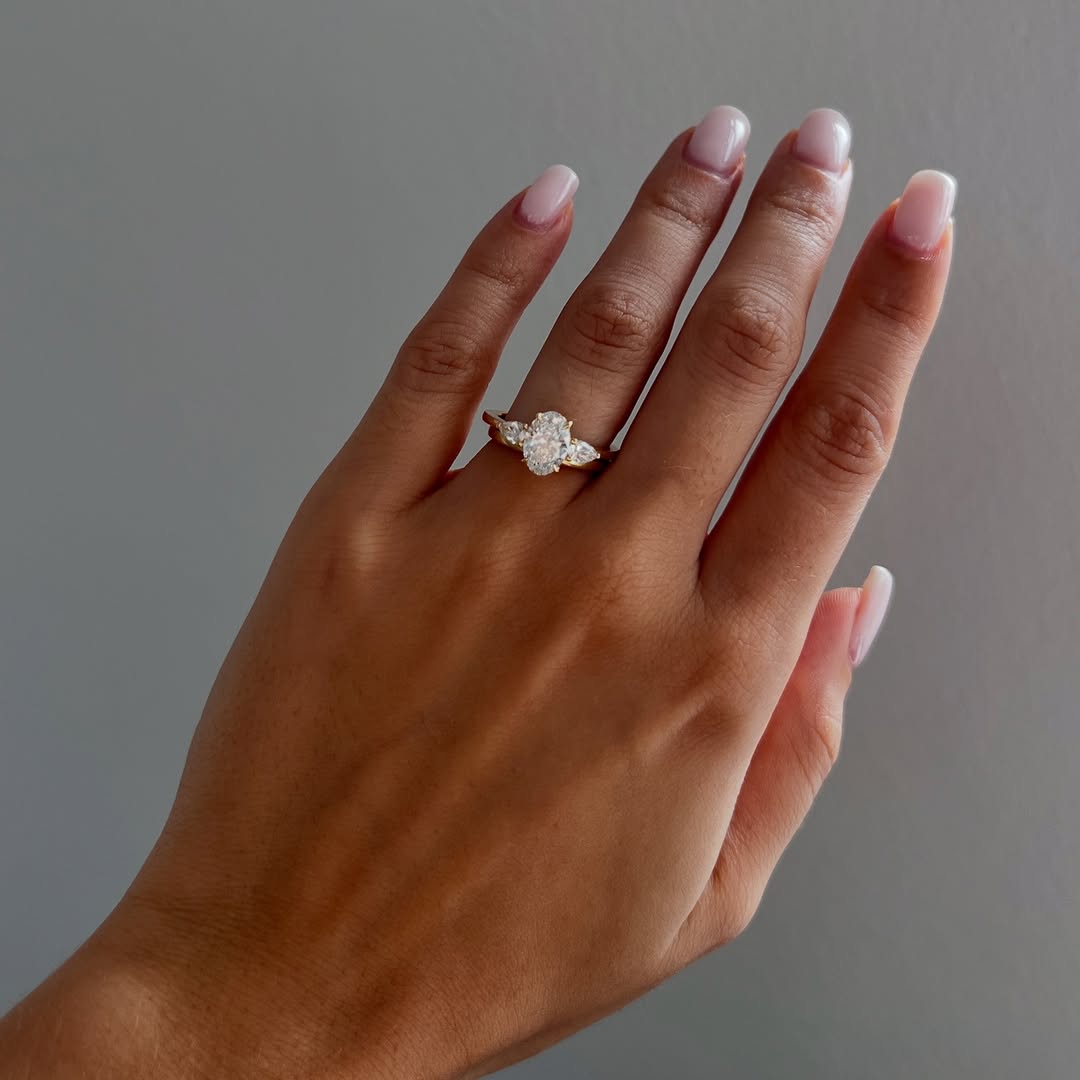 The Nyra Ring – Oval Three Stone Ring with Pear Side Stones