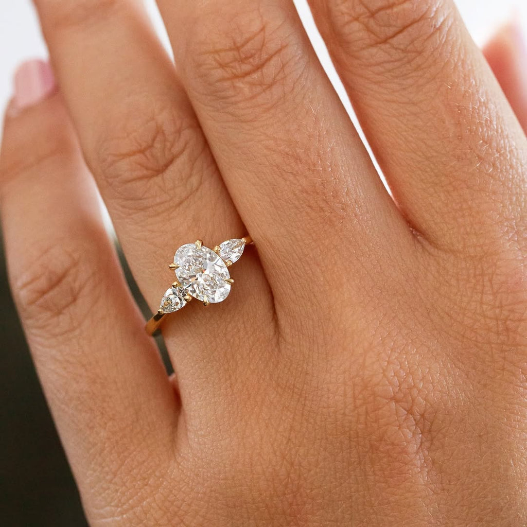 The Nyra Ring – Oval Three Stone Ring with Pear Side Stones