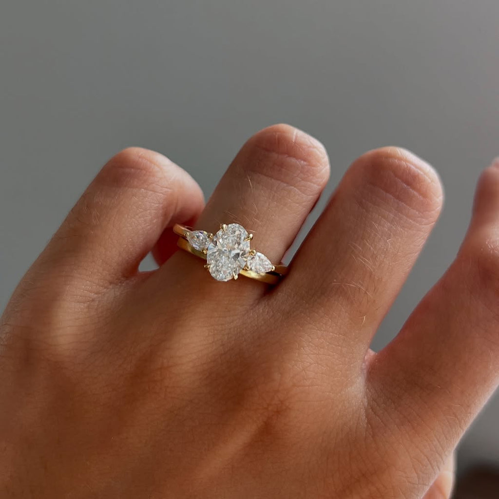 The Nyra Ring – Oval Three Stone Ring with Pear Side Stones