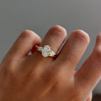 The Nyra Ring – Oval Three Stone Ring with Pear Side Stones