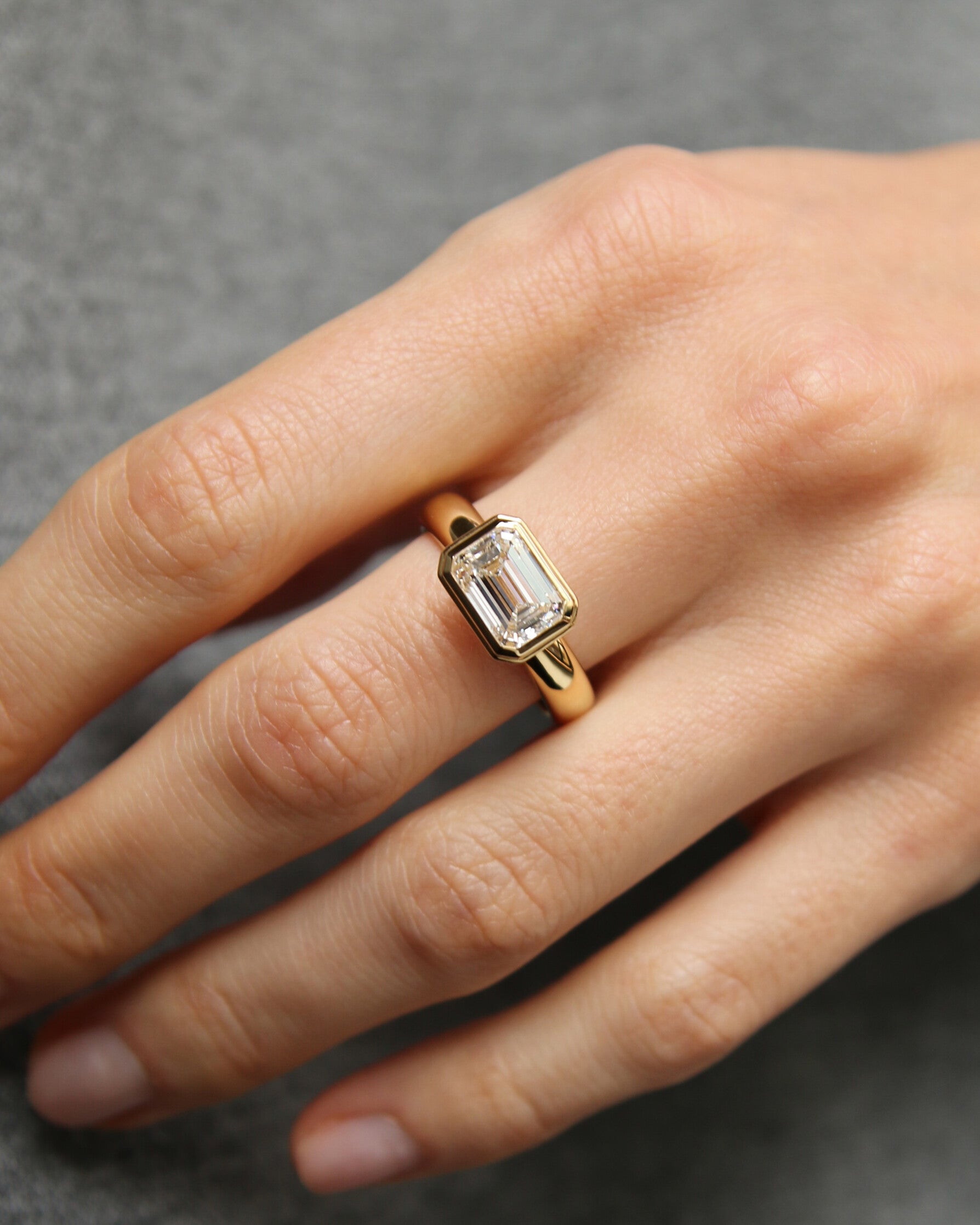 The Alina Ring - East-West Emerald Bezel Solitaire Ring
