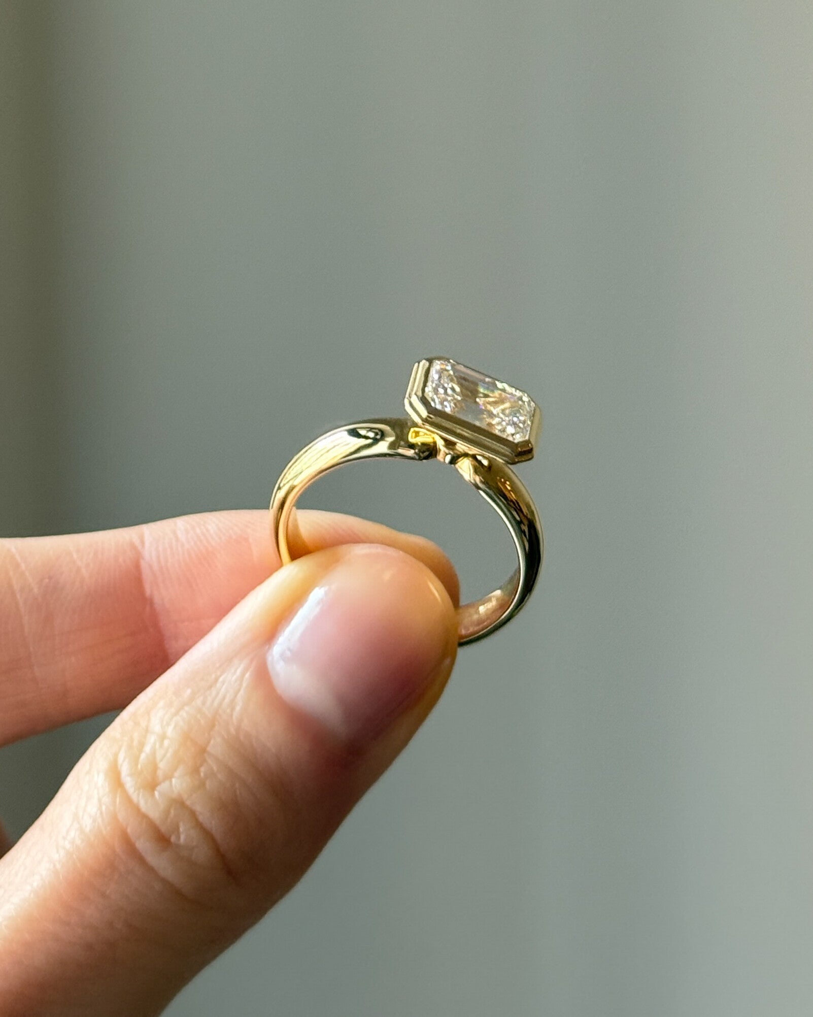 The Alina Ring - East-West Emerald Bezel Solitaire Ring