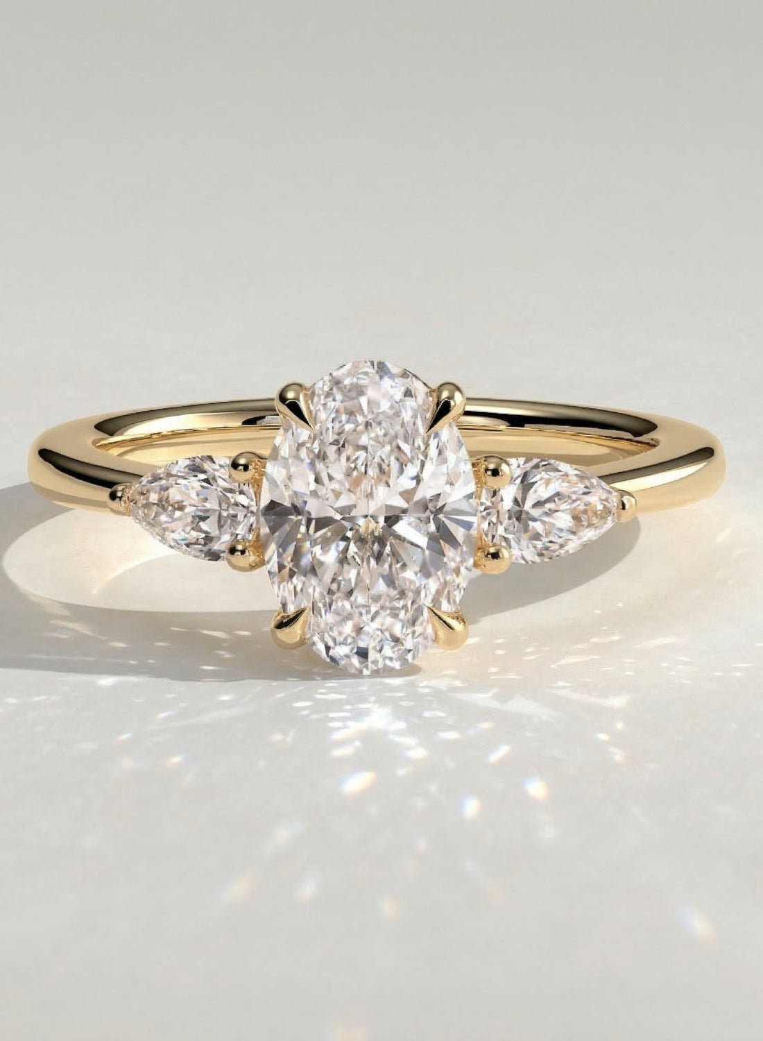 The Nyra Ring – Oval Three Stone Ring with Pear Side Stones